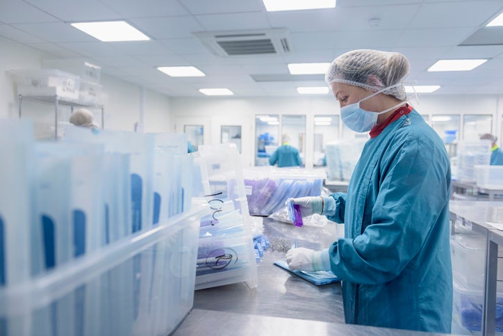 Workers packing surgical instruments