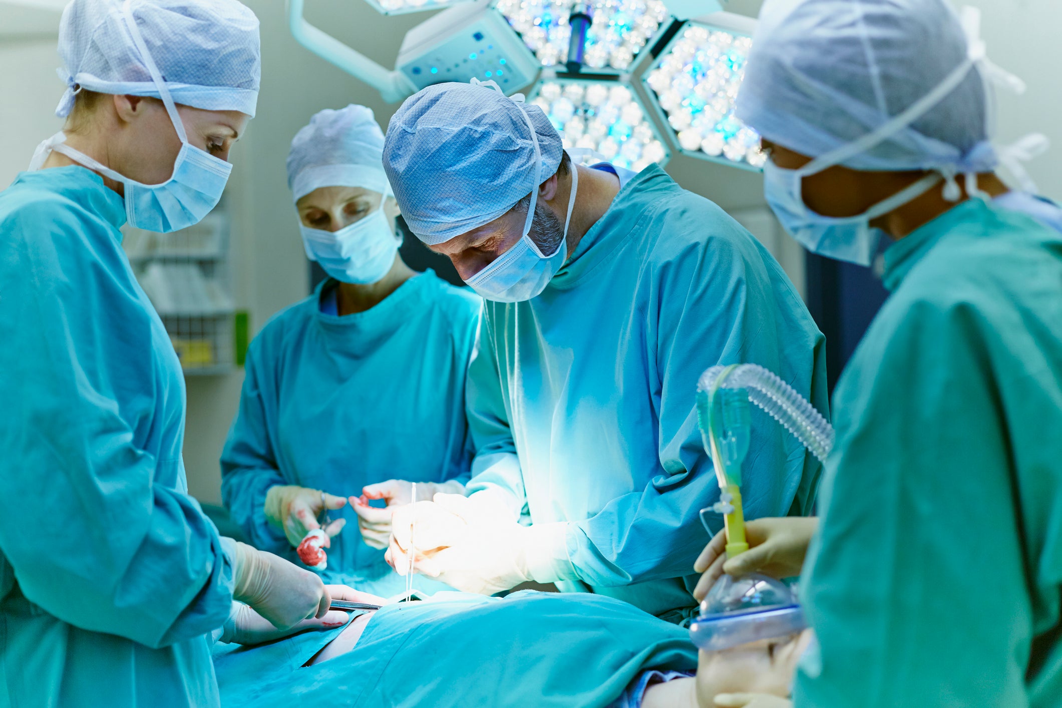 Surgeons performing surgery on a patient