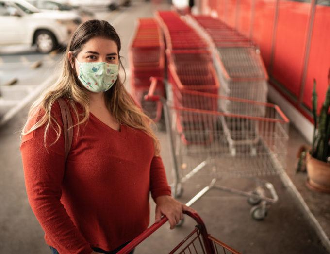 woman wearing mask with shopping cart