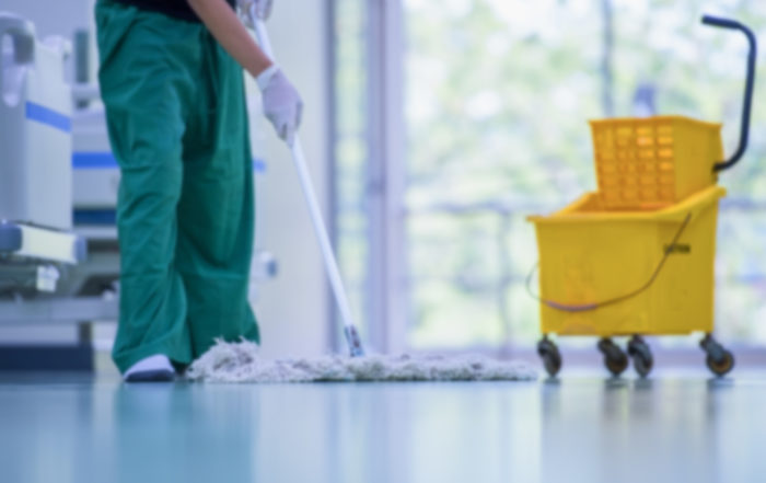 Hospital employee cleaning the floor