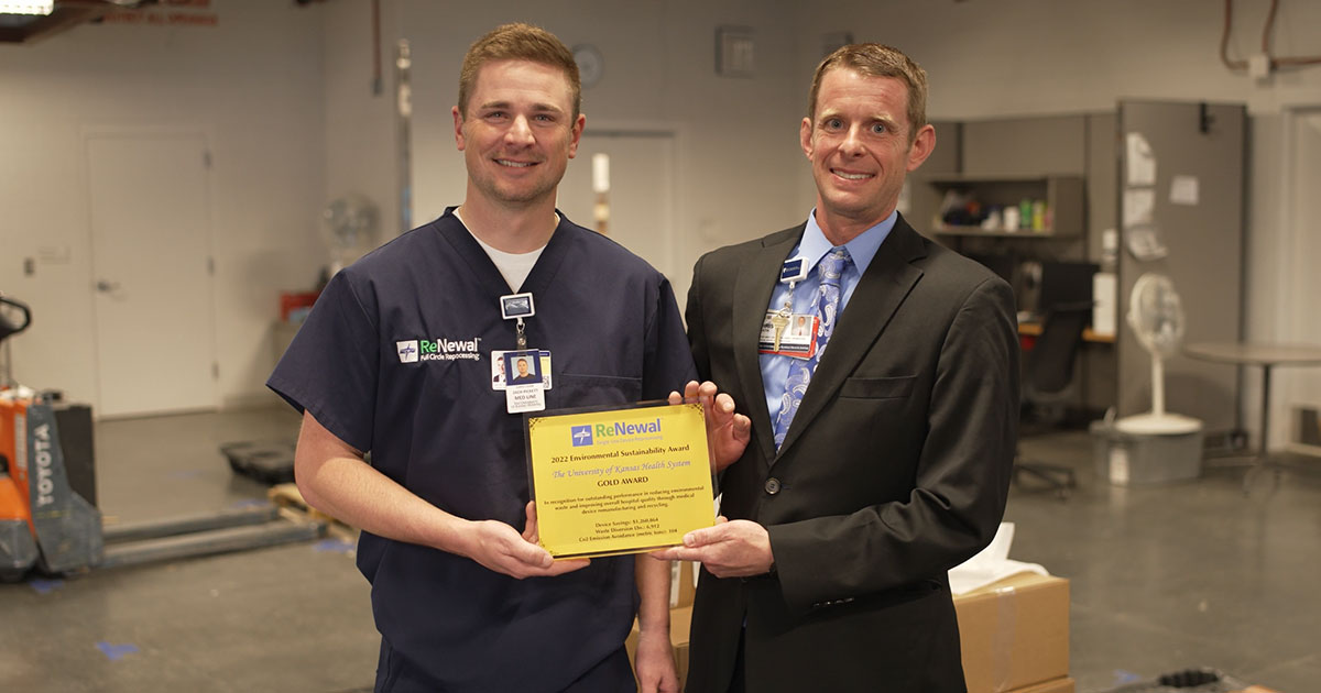Medline ReNewal Sales Specialist Zach Picket presents Chris Heath, The University of Kansas Health System director, clinical supply chain optimization, with the Medline ReNewal Gold 2022 Environmental Sustainability Award for medical device reprocessing efforts