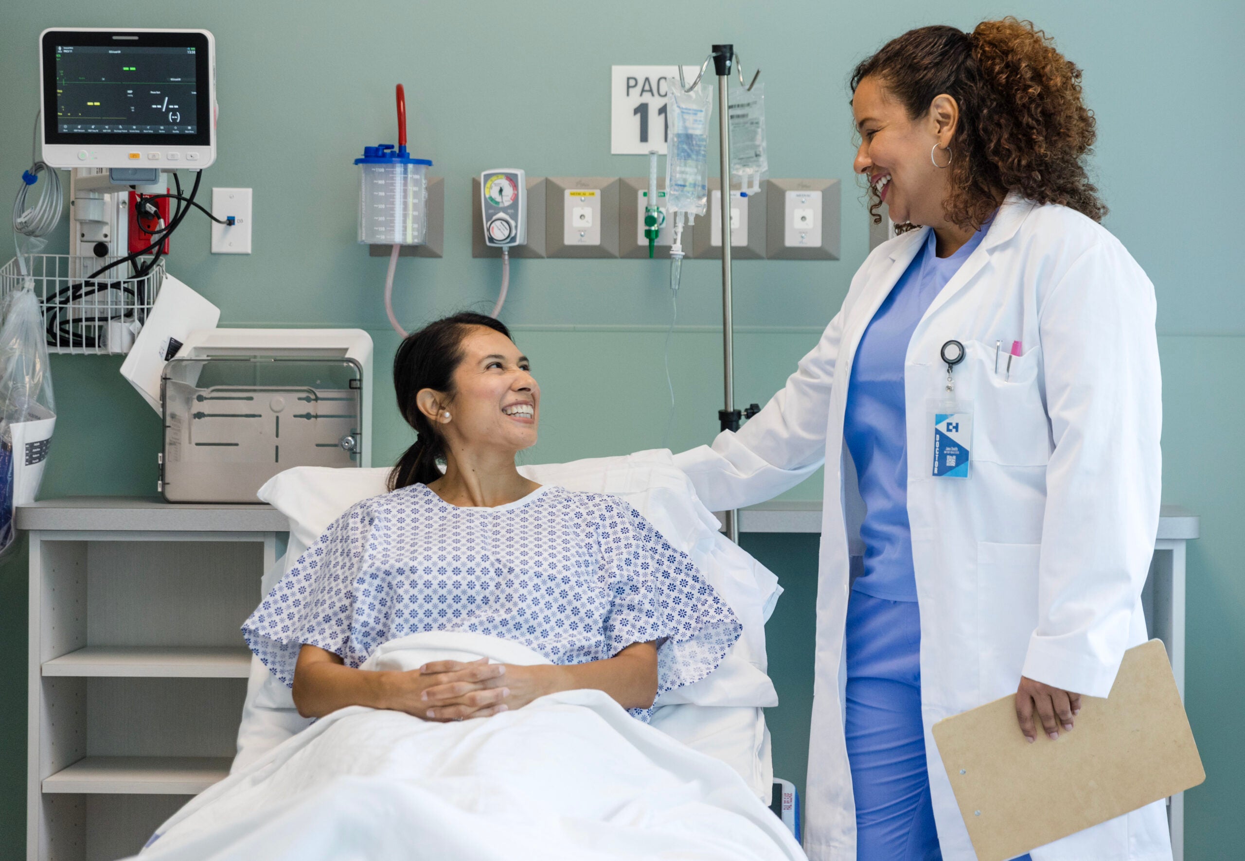 Female doctor smiles while talking to her patient
