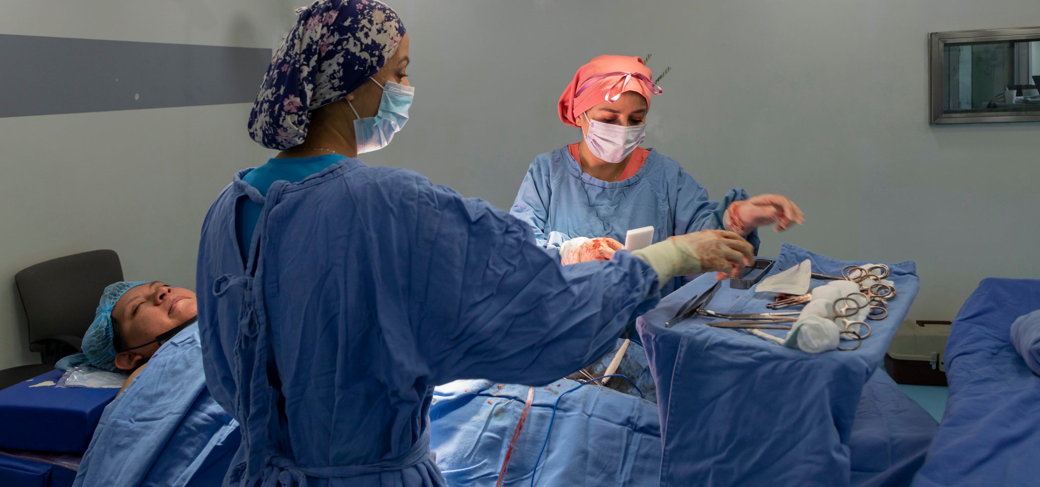 female surgeons perform a caesarean section on a mexican woman in the operating room